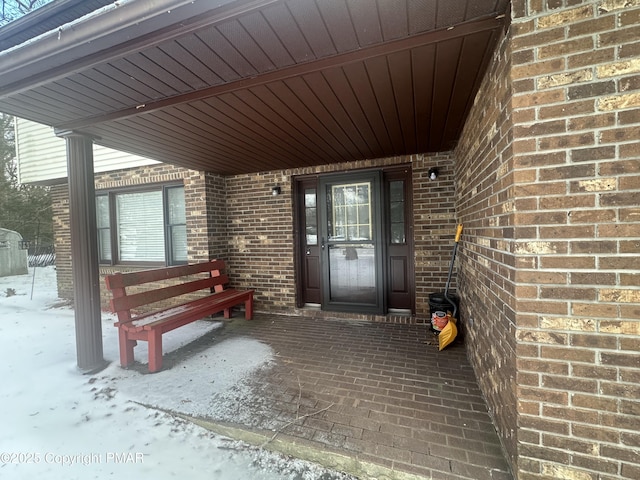 view of snow covered property entrance