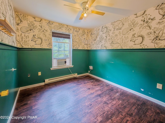 unfurnished room with wallpapered walls, a ceiling fan, wainscoting, wood finished floors, and baseboard heating