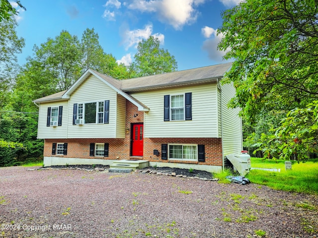 split foyer home featuring brick siding