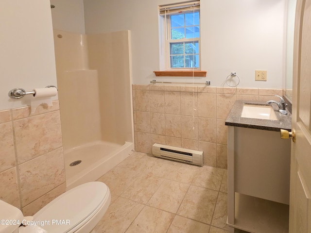 bathroom featuring toilet, a baseboard heating unit, vanity, tile walls, and walk in shower