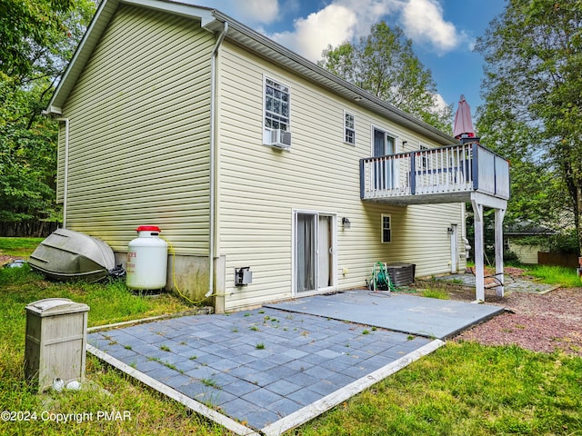 back of property featuring central air condition unit, cooling unit, and a patio