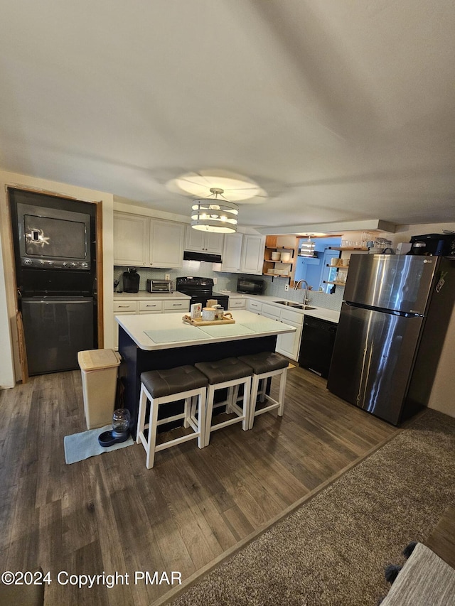 kitchen with black appliances, open shelves, a sink, and light countertops