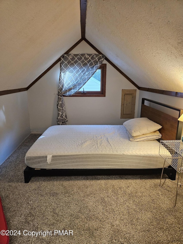 carpeted bedroom featuring lofted ceiling, electric panel, and a textured ceiling