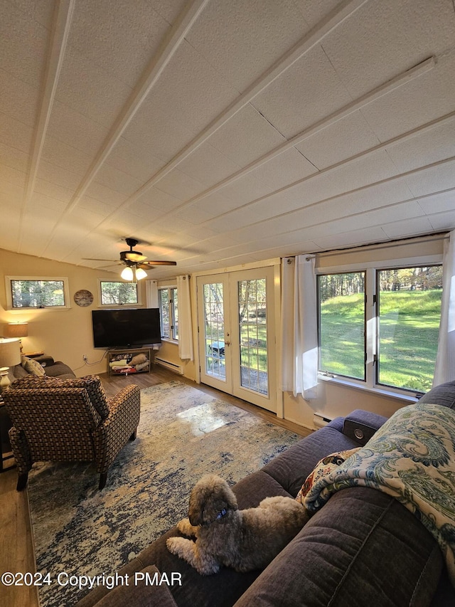 living area featuring plenty of natural light, wood finished floors, and french doors