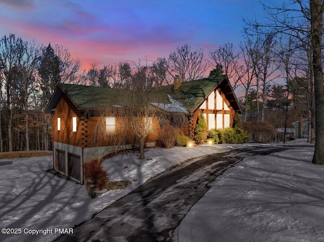 view of front of home with a garage and log siding