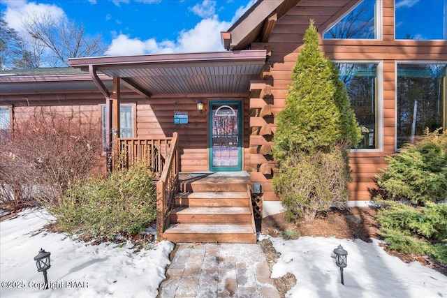 view of snow covered property entrance