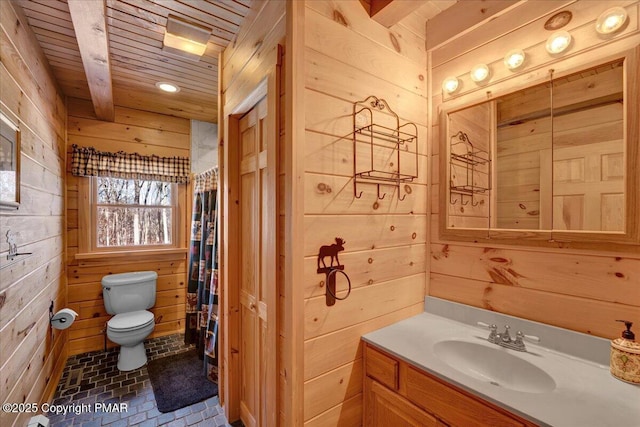 bathroom with wooden walls, vanity, wooden ceiling, toilet, and walk in shower