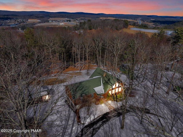 aerial view at dusk featuring a mountain view