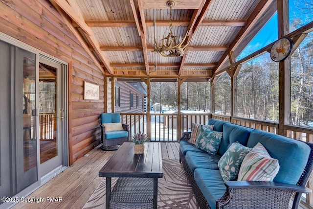 sunroom / solarium featuring wood ceiling, lofted ceiling with beams, and an inviting chandelier