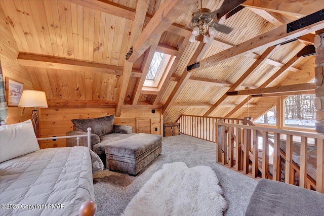 sitting room with a wealth of natural light, wooden ceiling, and wood walls