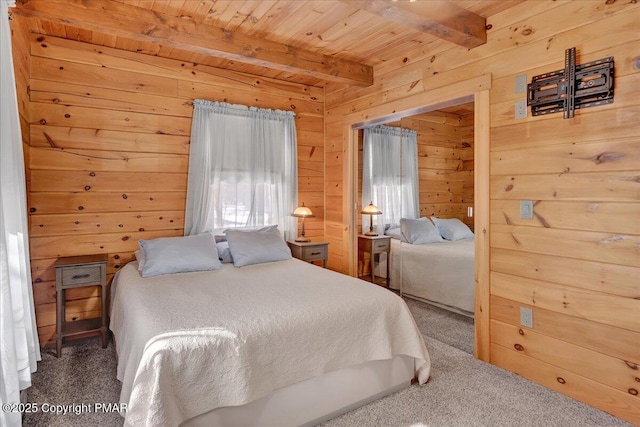 carpeted bedroom featuring beamed ceiling, wood ceiling, wooden walls, and multiple windows