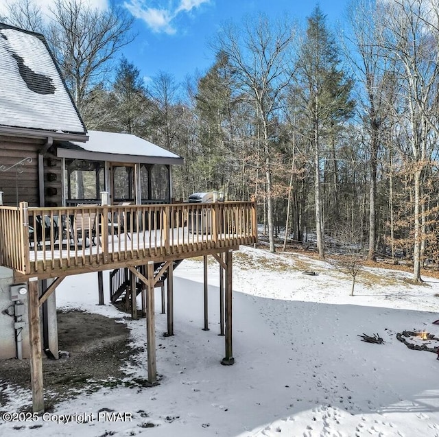 yard layered in snow featuring a wooden deck