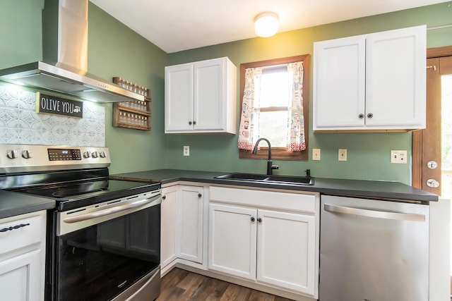 2227 Cheyenne Dr, Blakeslee, PA 18610 - kitchen featuring appliances with stainless steel finishes, wall chimney exhaust hood, dark countertops, and white cabinets