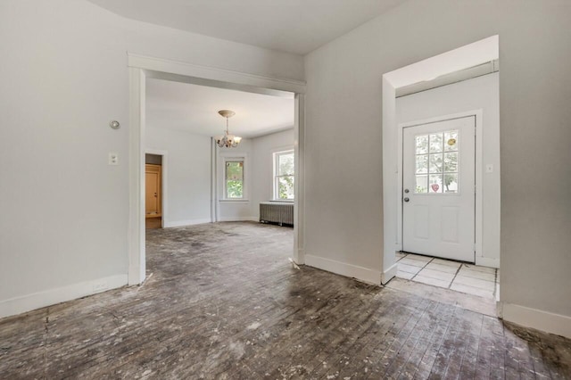 1198 W Main St, Stroudsburg, PA 18360 - foyer entrance featuring a chandelier, radiator heating unit, and wood-type flooring