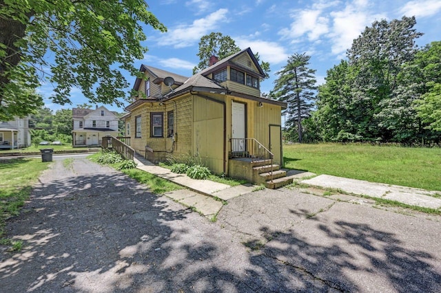 1198 W Main St, Stroudsburg, PA 18360 - view of front of property featuring a chimney, a front yard, and driveway