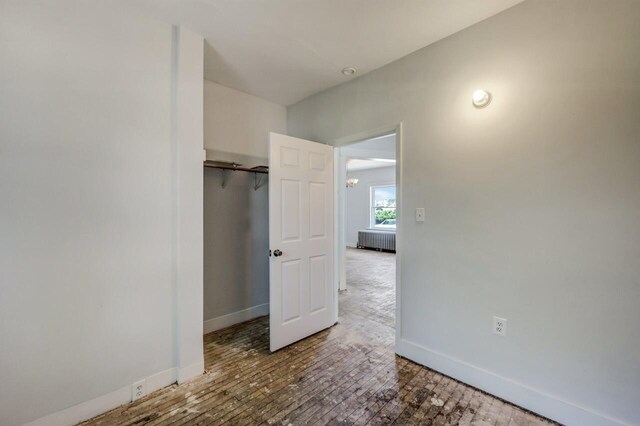 1198 W Main St, Stroudsburg, PA 18360 - unfurnished bedroom with radiator heating unit and hardwood / wood-style flooring