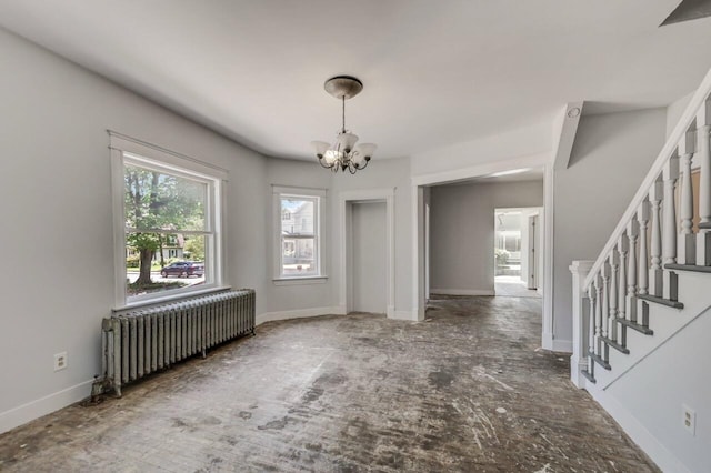 1198 W Main St, Stroudsburg, PA 18360 - dining space with radiator heating unit, a chandelier, and stairs