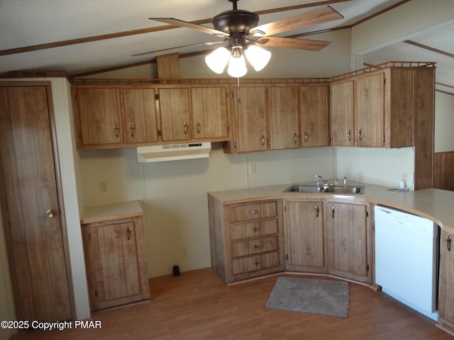 kitchen with light wood finished floors, lofted ceiling, white dishwasher, light countertops, and a sink