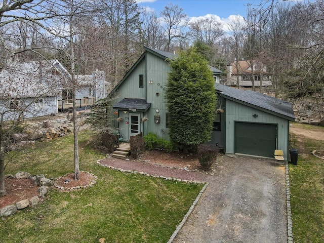 7924 Sleepy Hollow Dr, Tobyhanna, PA 18466 - view of front of home featuring dirt driveway, a shingled roof, an attached garage, and a front lawn
