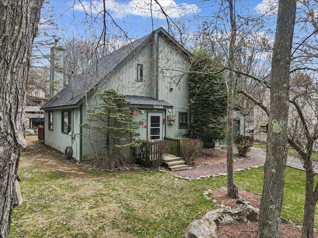 7924 Sleepy Hollow Dr, Tobyhanna, PA 18466 - view of front of house featuring a shingled roof, a front lawn, and a chimney