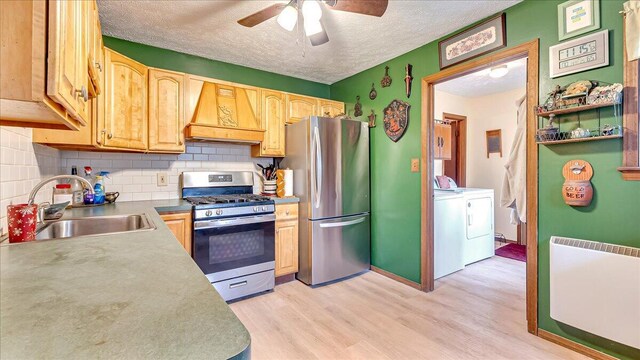 7924 Sleepy Hollow Dr, Tobyhanna, PA 18466 - kitchen featuring a ceiling fan, appliances with stainless steel finishes, washing machine and dryer, a sink, and premium range hood