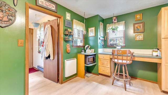 7924 Sleepy Hollow Dr, Tobyhanna, PA 18466 - home office with a textured ceiling, a baseboard radiator, built in desk, and light wood-type flooring