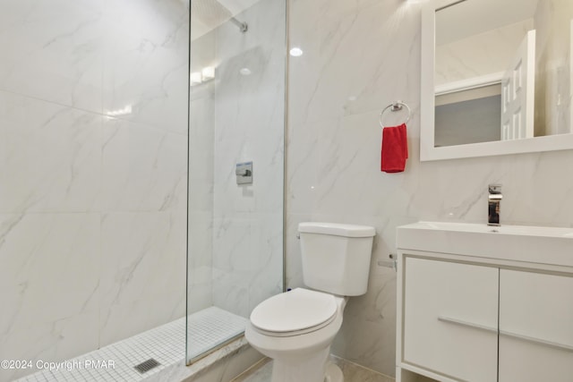 full bathroom with vanity, a marble finish shower, and toilet