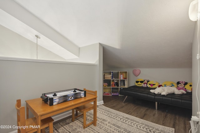 home office with lofted ceiling and wood finished floors