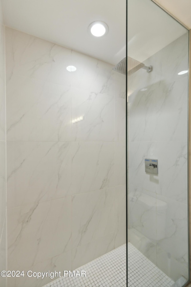 full bathroom featuring a marble finish shower