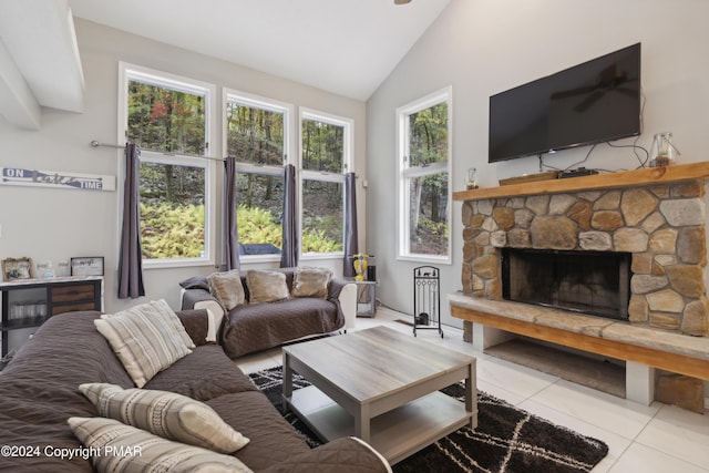 tiled living area with lofted ceiling and a fireplace