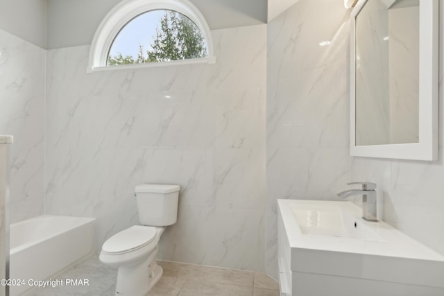 bathroom with tile walls, toilet, tile patterned floors, vanity, and a bath