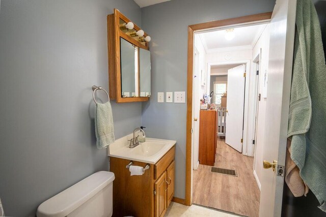 243 R Own Rd, East Stroudsburg, PA 18302 - half bath with ornamental molding, vanity, and wood finished floors