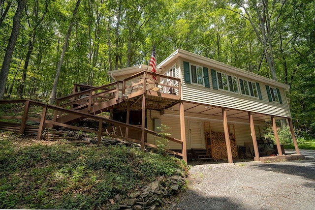 243 R Own Rd, East Stroudsburg, PA 18302 - view of front of property featuring stairway, a wooden deck, and gravel driveway