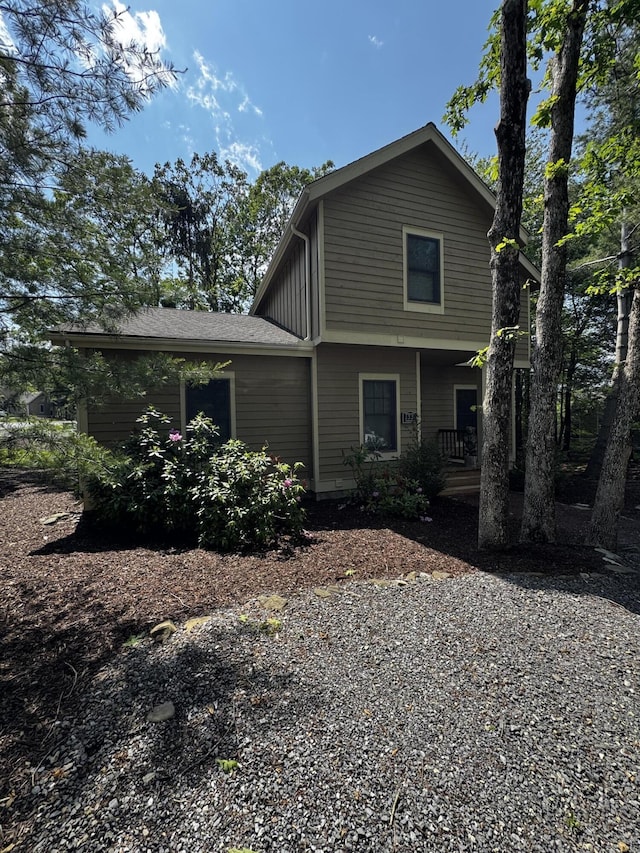 view of side of property with covered porch