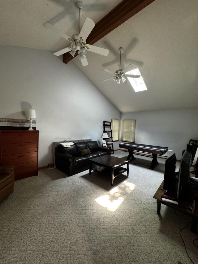 carpeted living area with a ceiling fan, beamed ceiling, a skylight, and high vaulted ceiling