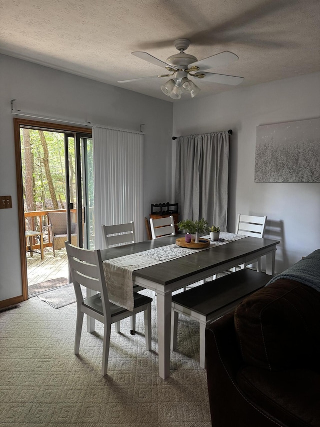 dining room with a ceiling fan, a textured ceiling, and carpet floors