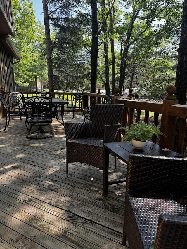 wooden terrace featuring outdoor dining space