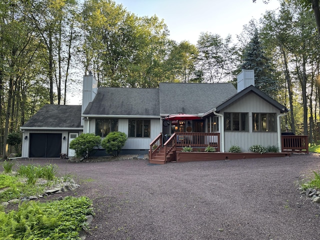 1161 Deer, Pocono Pines, PA 18350 - view of front of property with a chimney, a garage, asphalt driveway, and a sunroom