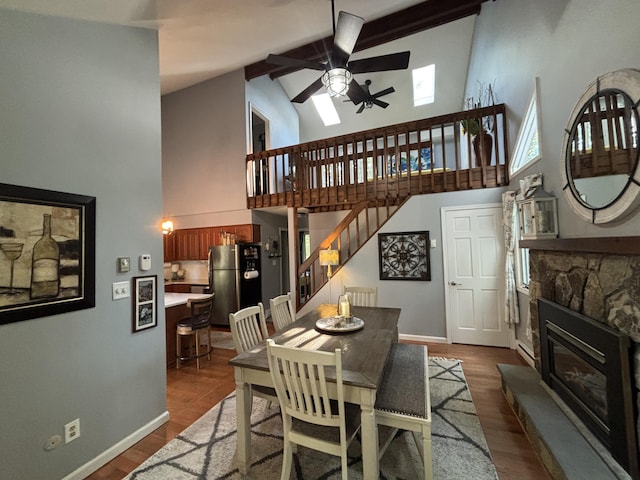 1161 Deer, Pocono Pines, PA 18350 - dining area featuring high vaulted ceiling, a ceiling fan, dark wood finished floors, a fireplace, and beam ceiling