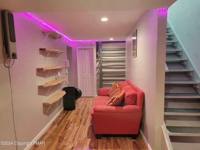 interior space with stairway, baseboards, wood finished floors, and recessed lighting