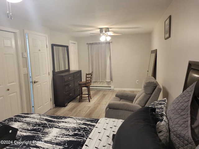 bedroom featuring light wood-style floors, a baseboard radiator, and a ceiling fan