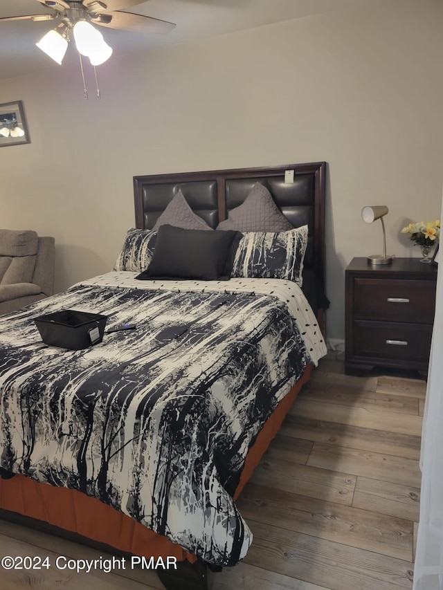 bedroom with ceiling fan and wood finished floors