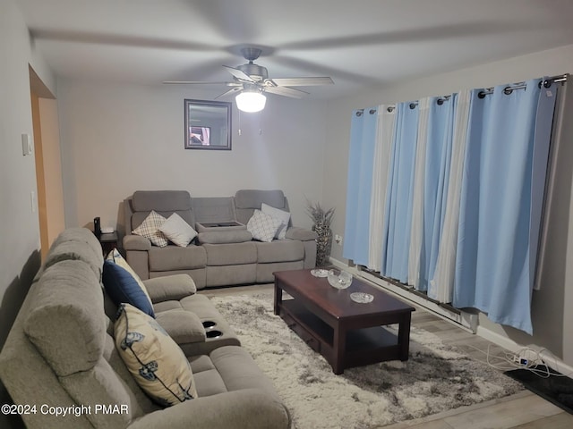 living room featuring ceiling fan and baseboards