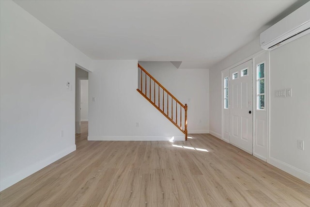 113 Dennis Ct, East Stroudsburg, PA 18301 - foyer entrance with a wall mounted air conditioner, light wood-style flooring, and stairway