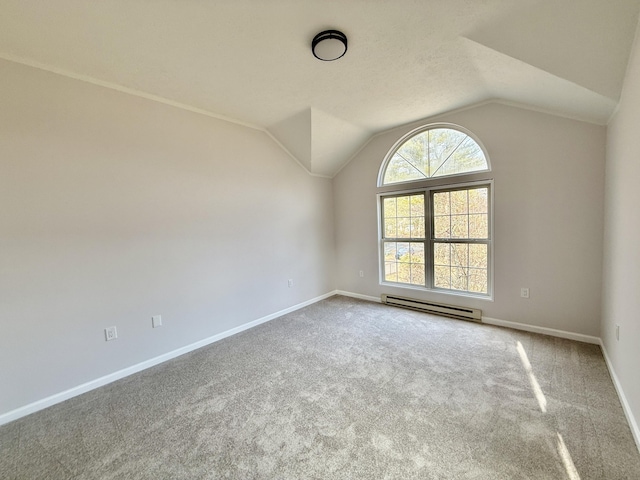 carpeted spare room with lofted ceiling, a baseboard radiator, and baseboards