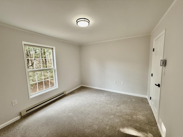 spare room with a baseboard heating unit, carpet, ornamental molding, and baseboards