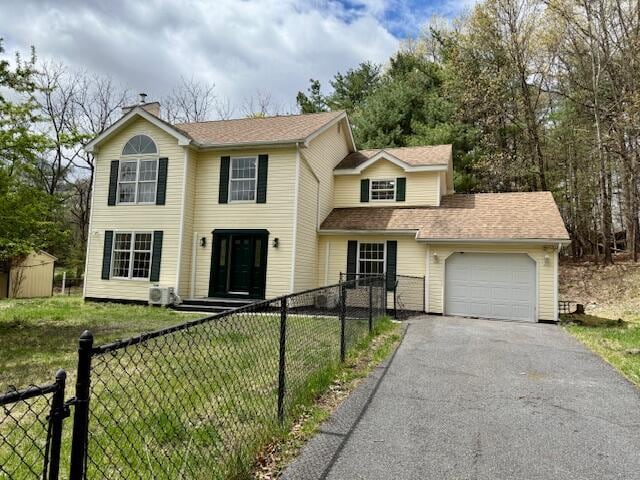 113 Dennis Ct, East Stroudsburg, PA 18301 - view of front of house with driveway, a chimney, a front yard, an attached garage, and fence private yard