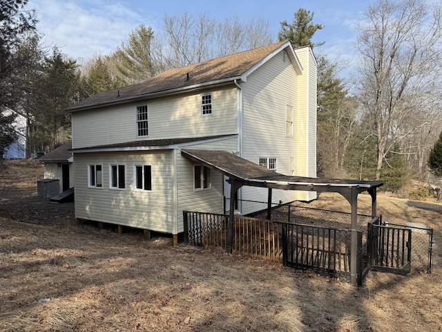 rear view of property with fence