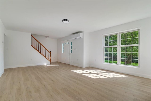 113 Dennis Ct, East Stroudsburg, PA 18301 - foyer entrance with an AC wall unit, stairway, and light wood finished floors