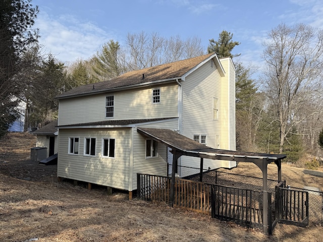 rear view of property with fence